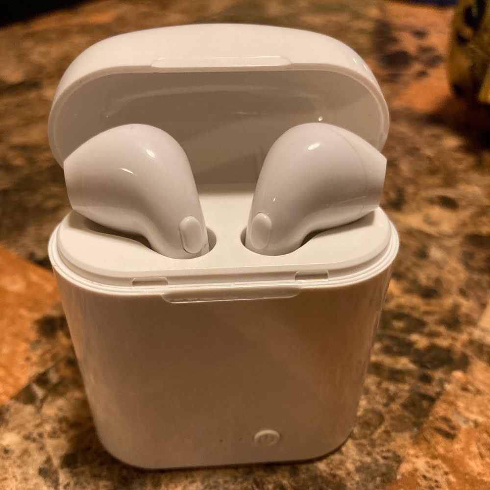 AirPods.Wireless headphones with charging case.